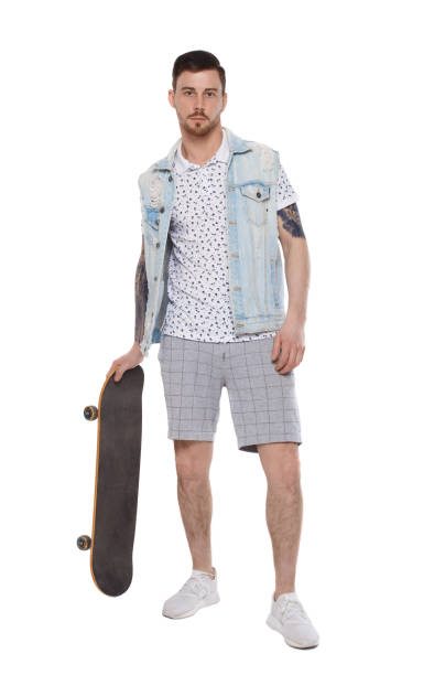 istock A man in shorts with a skateboard. 1128087238