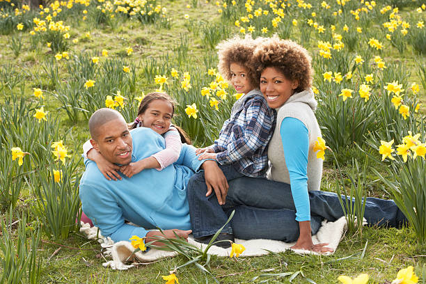 Portrait of happy family together hugging near their big house.