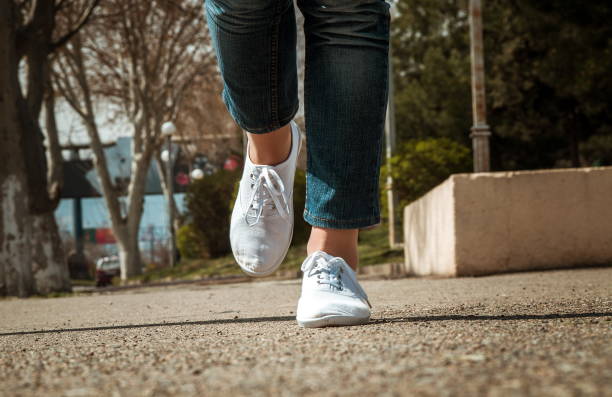 istock Low Section Of Woman Walking On Road 1128090006