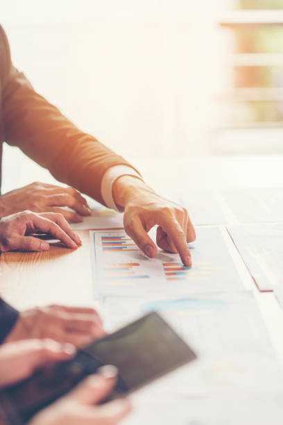 istock Business People Working Over Graphs On Table At Office 1128092356