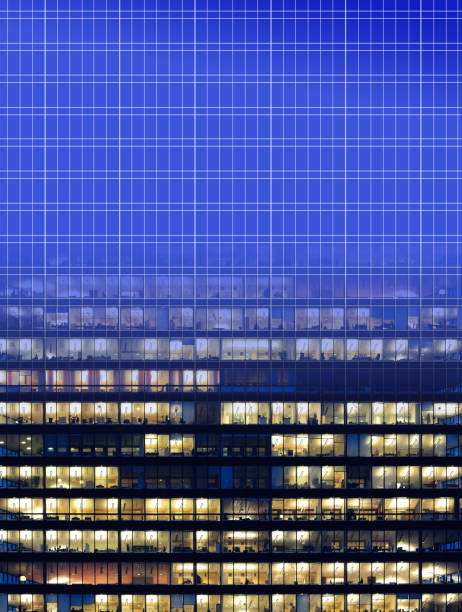 istock Blueprint drawing and finished building: Workers working late. Office windows by night. 1128095563