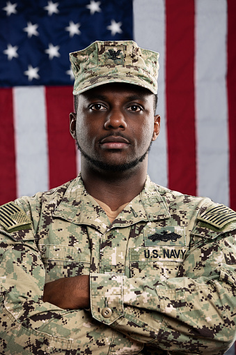 African American Service Man wearing the official US Navy Seabees uniform. The Seabees are the engineers of the US Navy and work closely with the US Marines. The model is an actual veteran.