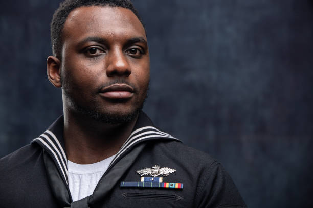 US Navy Seabee Service Member African American Service Man wearing the official US Navy Seabees uniform. The Seabees are the engineers of the US Navy and work closely with the US Marines. The model is an actual veteran. black military man stock pictures, royalty-free photos & images