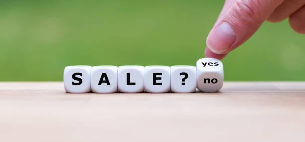 istock On sale? Hand turns a dice and changes the word 