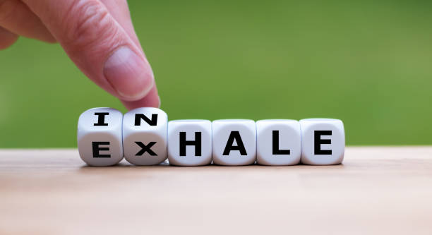 istock Inhale,Exhale concept. Hand turns dice and changes the word 
