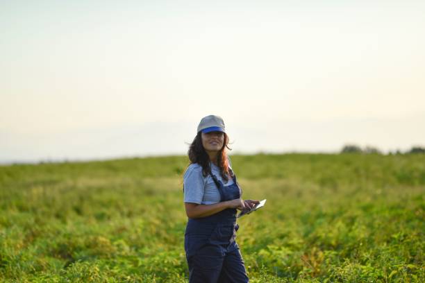 istock Young female farmer with digital tablet 1128097231
