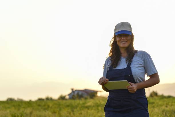 istock Young female farmer with digital tablet 1128097861