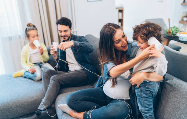 istock Family having fun with string phones 1128097912