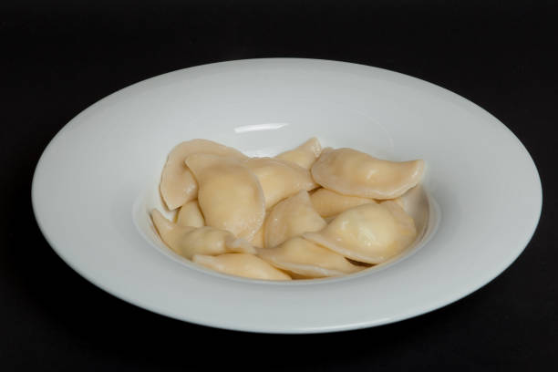 istock Spinach Dumplings in a white plate on a black background 1128097956