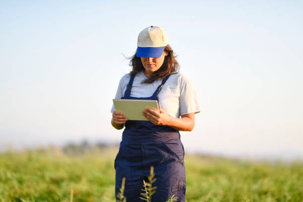 istock Young female farmer with digital tablet 1128098108