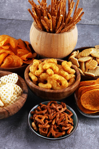 istock Salty snacks. Pretzels, chips, crackers in wooden bowls. 1128098189