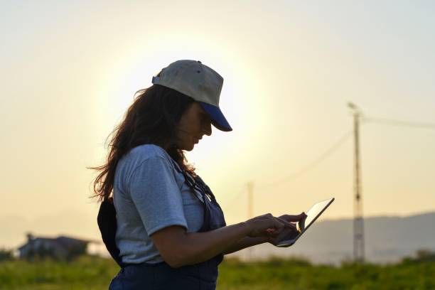 istock Young female farmer with digital tablet 1128098193