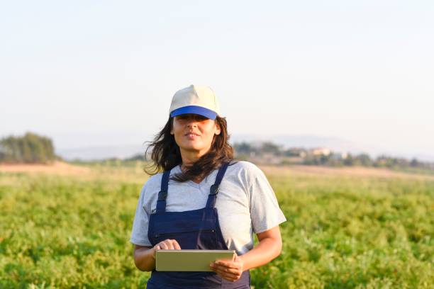 istock Young female farmer with digital tablet 1128098207