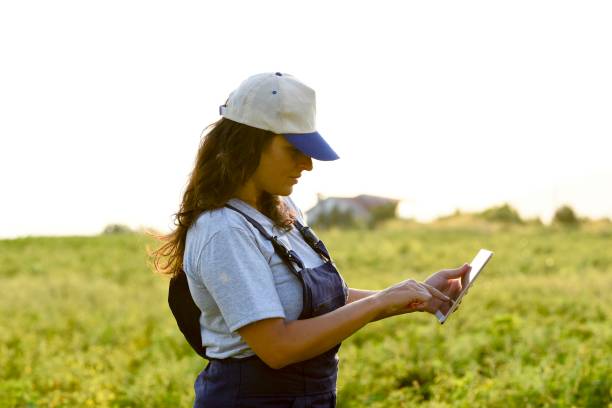 istock Young female farmer with digital tablet 1128098254