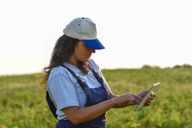 istock Young female farmer with digital tablet 1128098289