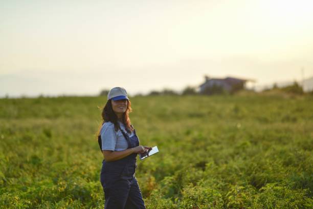 istock Young female farmer with digital tablet 1128099606