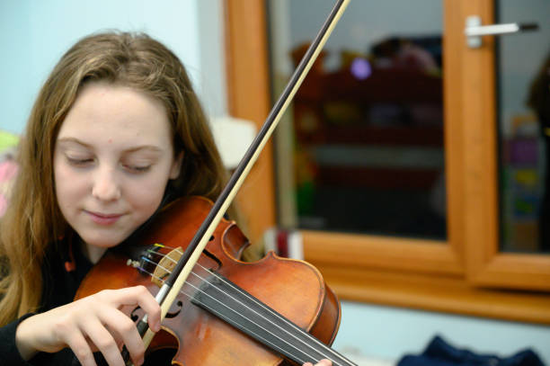 istock Girl playing violin 1128099625