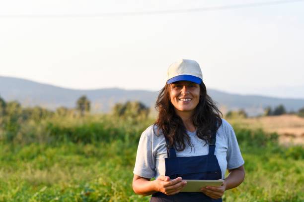 istock Young female farmer with digital tablet 1128099693