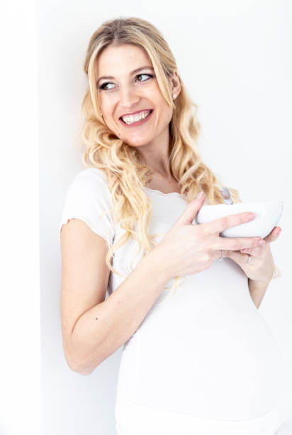 istock Happy pregnant woman having breakfast 1128099738