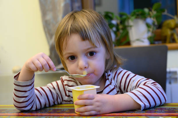 istock Little girl eating at home 1128099820