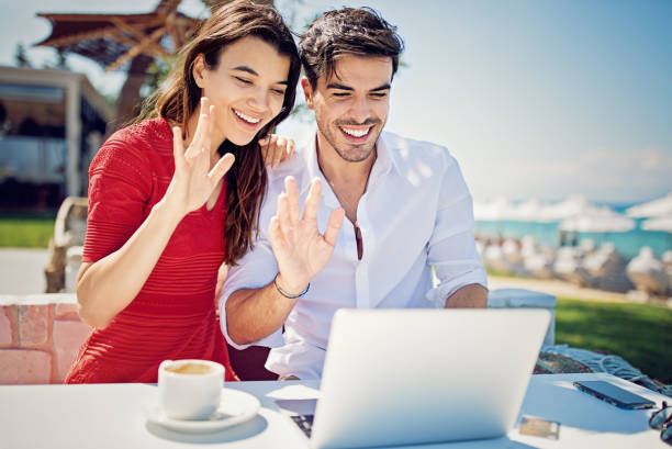istock Couple is hugging and making video call on the beach 1128099892