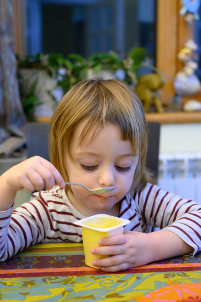 istock Little girl eating at home 1128099987