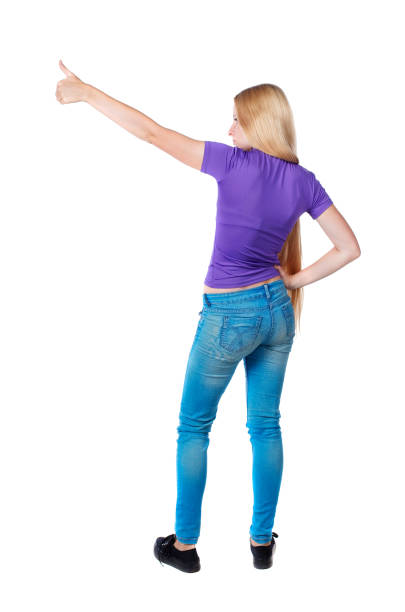 istock Back view of  pointing woman. 1128101285