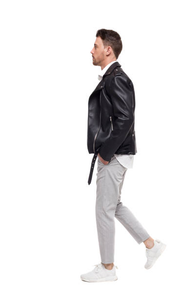 istock Side view of going  handsome man in a leather jacket and trouser 1128101307