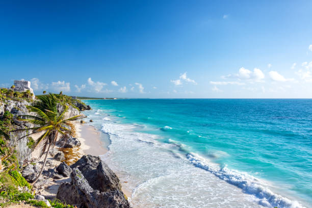 Tulum Ruins and Caribbean Wide Angle Wide angle view of the beautiful Caribbean Sea and the ruins of Tulum, Mexico cancun stock pictures, royalty-free photos & images