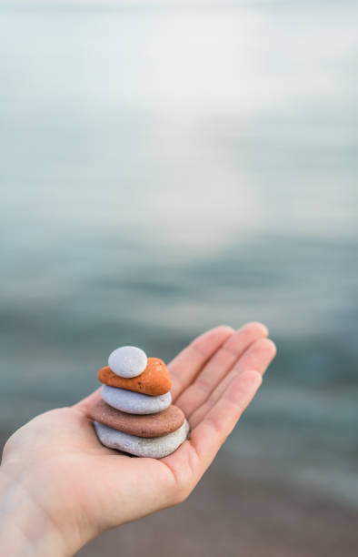 istock Pile of stacked stones in human hand 1128105096