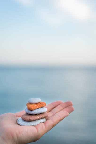 istock Pile of stacked stones in human hand 1128105207