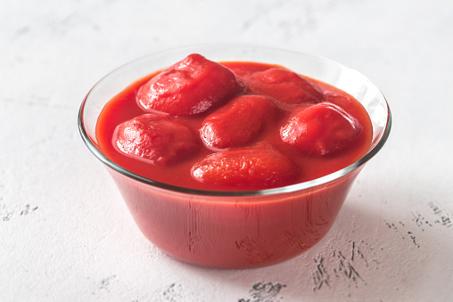 Bowl of canned tomatoes on the table