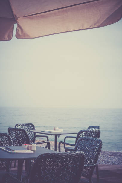 istock Wicker chairs by the empty outdoor restaurant tables 1128111420