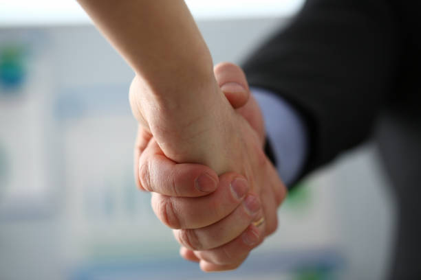 istock Man in suit and tie give hand as hello in office 1128114145
