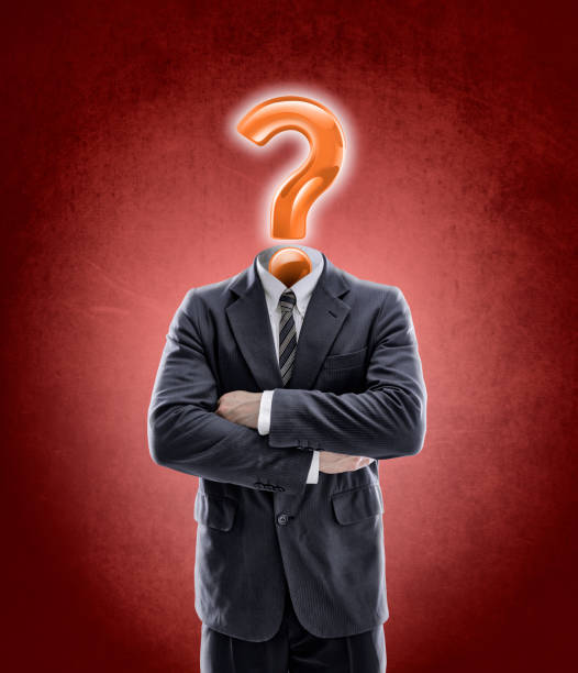 istock Question mark as head on businessman in a suit with arms crossed 1128114634