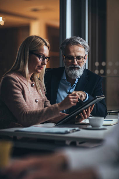 istock Working late with business colleague  in office 1128117151