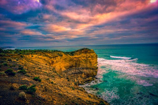 istock Colorful sky above the cliffs next to the beach 1128117325