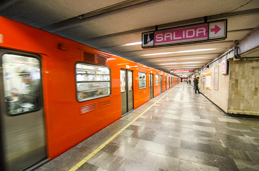 Mexico City, Mexico - October 31, 2016: People just boarded a subway train in Mexico City. The metro system in the city has special cars just for woman. There are police guards outside the boarding areas for extra safety.