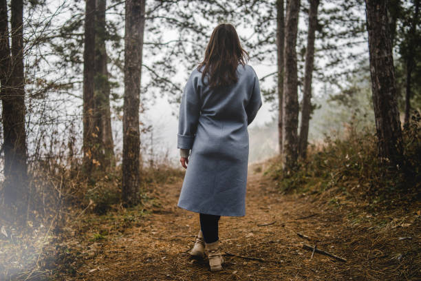 istock Young Woman On The Path In Forest 1128118950