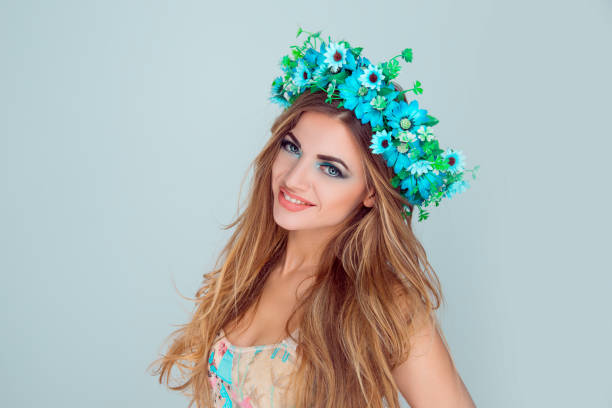 istock woman with floral crown on head smiling looking at camera 1128119269
