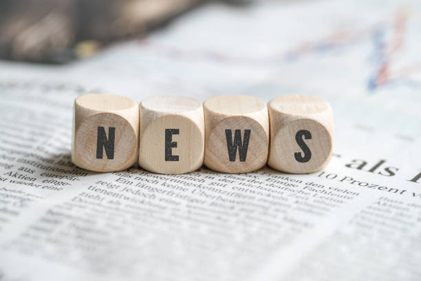 cubes with the word "news" on a newspaper cubes with the word "news" on a newspaper article photos stock pictures, royalty-free photos & images