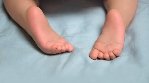 istock Orthopediatrics problems. Crawling background. Brain development of baby. First steps. Little barefeet. Baby's feet. Barefeeted baby. Children's feet. 1128119994