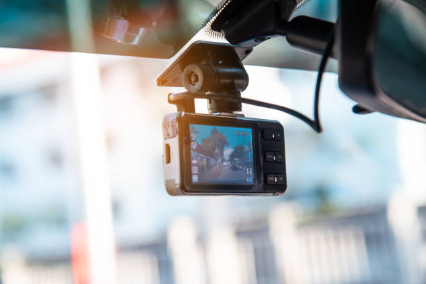 Car video camera attached to the windshield to record driving and prevent danger from driving Car video camera attached to the windshield to record driving and prevent danger from driving dashboard vehicle part photos stock pictures, royalty-free photos & images