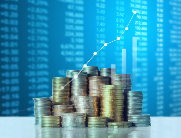 istock Coins graph stock market 1128123958