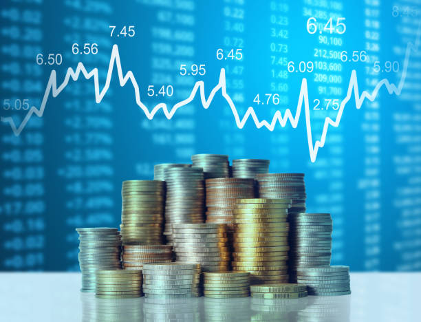 istock Coins graph stock market 1128123961