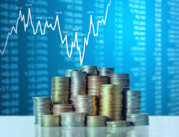 istock Coins graph stock market 1128123964