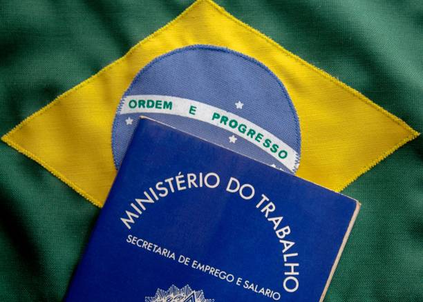 istock Brazilian document work and social security (Carteira de Trabalho e Previdencia Social) on brazilian flag 1128127294