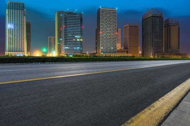 istock night view of Empty asphalt road through modern city 1128131144