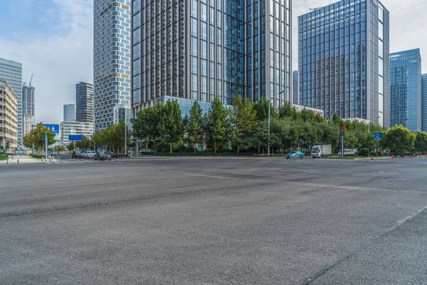istock empty road and modern office block buildings against sky, china. 1128131269