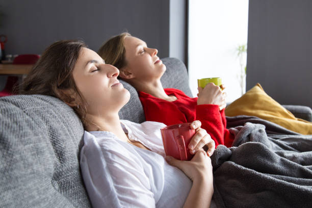 istock Female roommates having cold and resting at home 1128131927